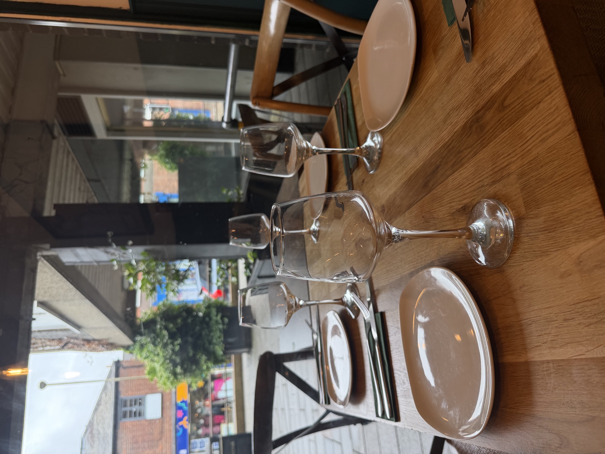 Window seating overlooking St George's Street with wine glasses set