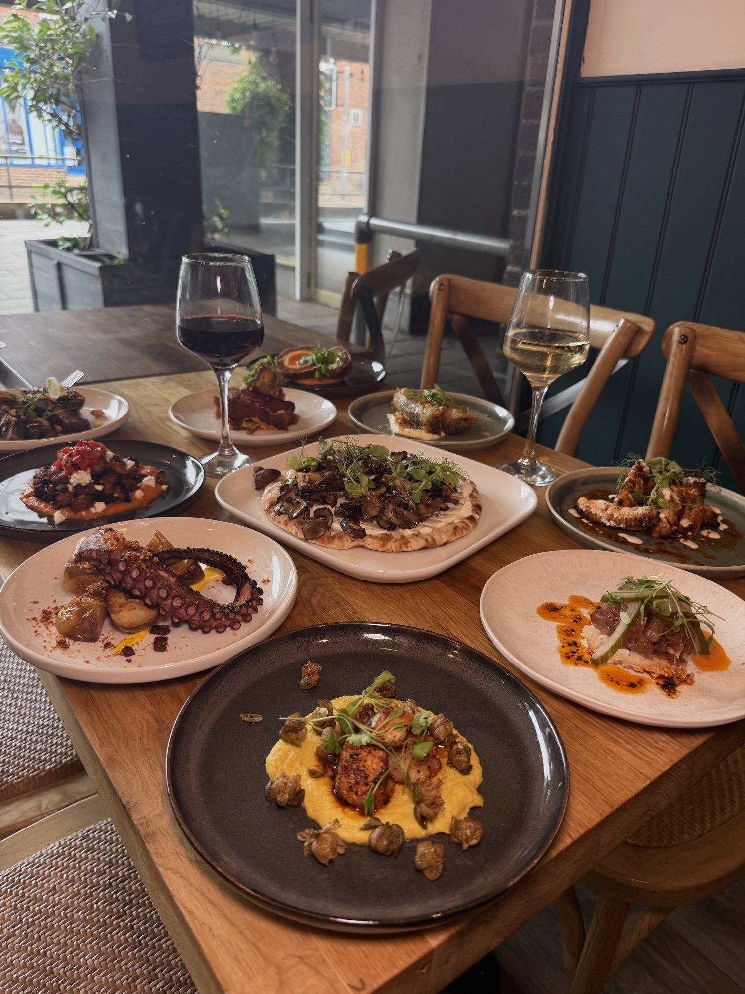 Mezze spread with wine by the window at MIXA